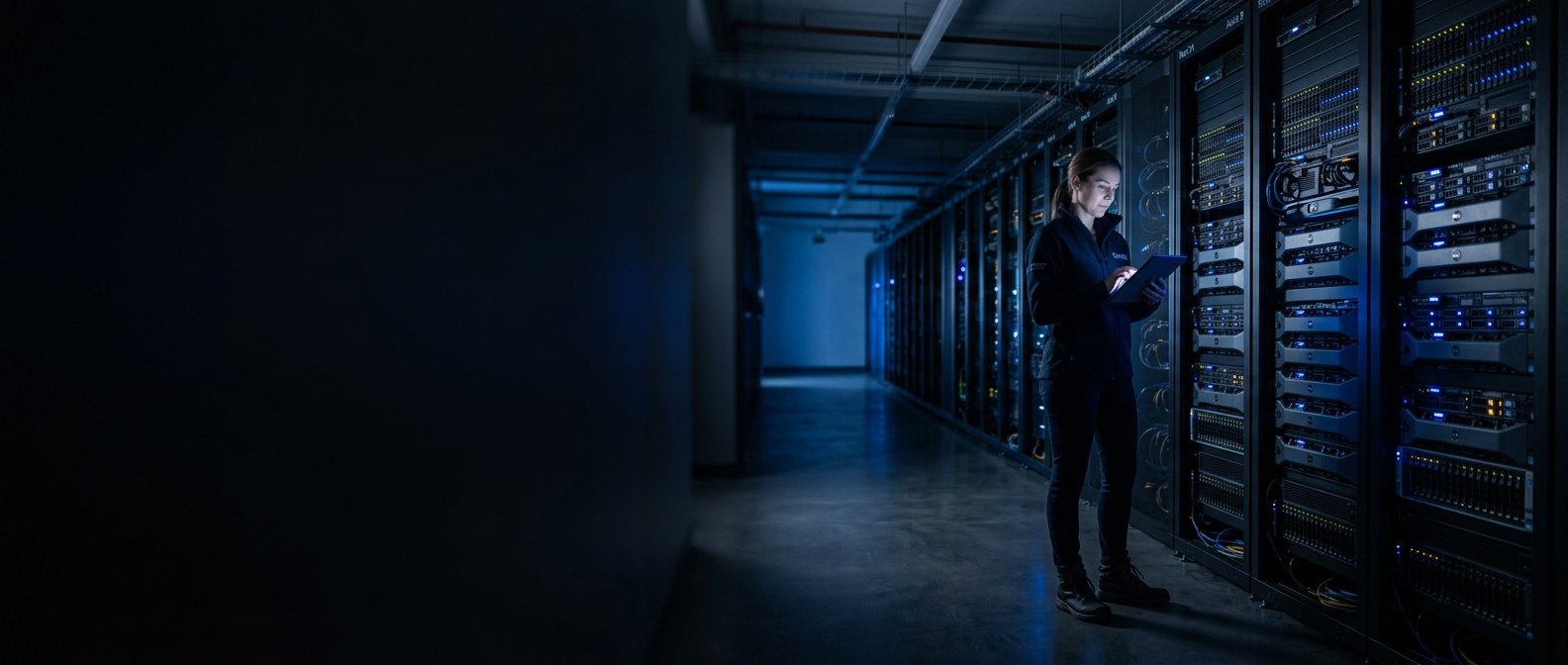 Engineer reviewing server status in a modern enterprise data center